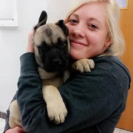 Staci - Veterinary Assistant holding a puppy at Animal Care Clinic West & Metro Cat Hospital